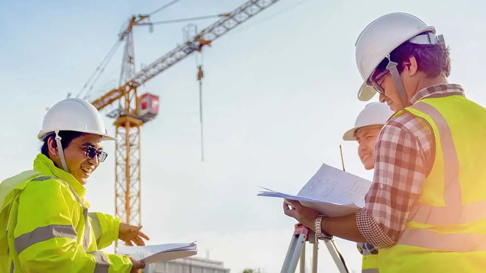 Site team in hard hats and hi-vis vests during on-site safety training